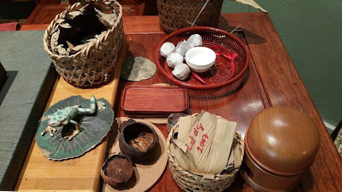 Assorted woven baskets, dishes, and wooden containers arranged on a table.