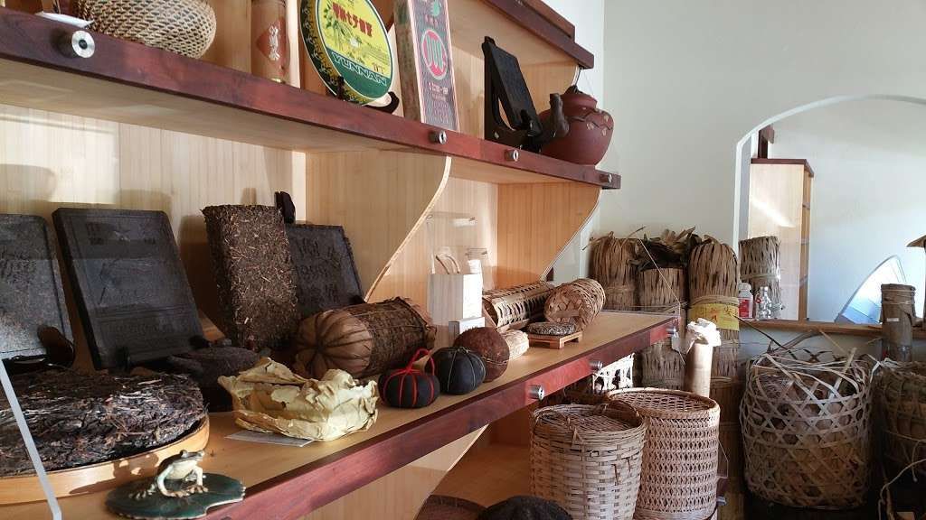 Shelves of woven baskets, pottery, and decor in a cozy shop interior