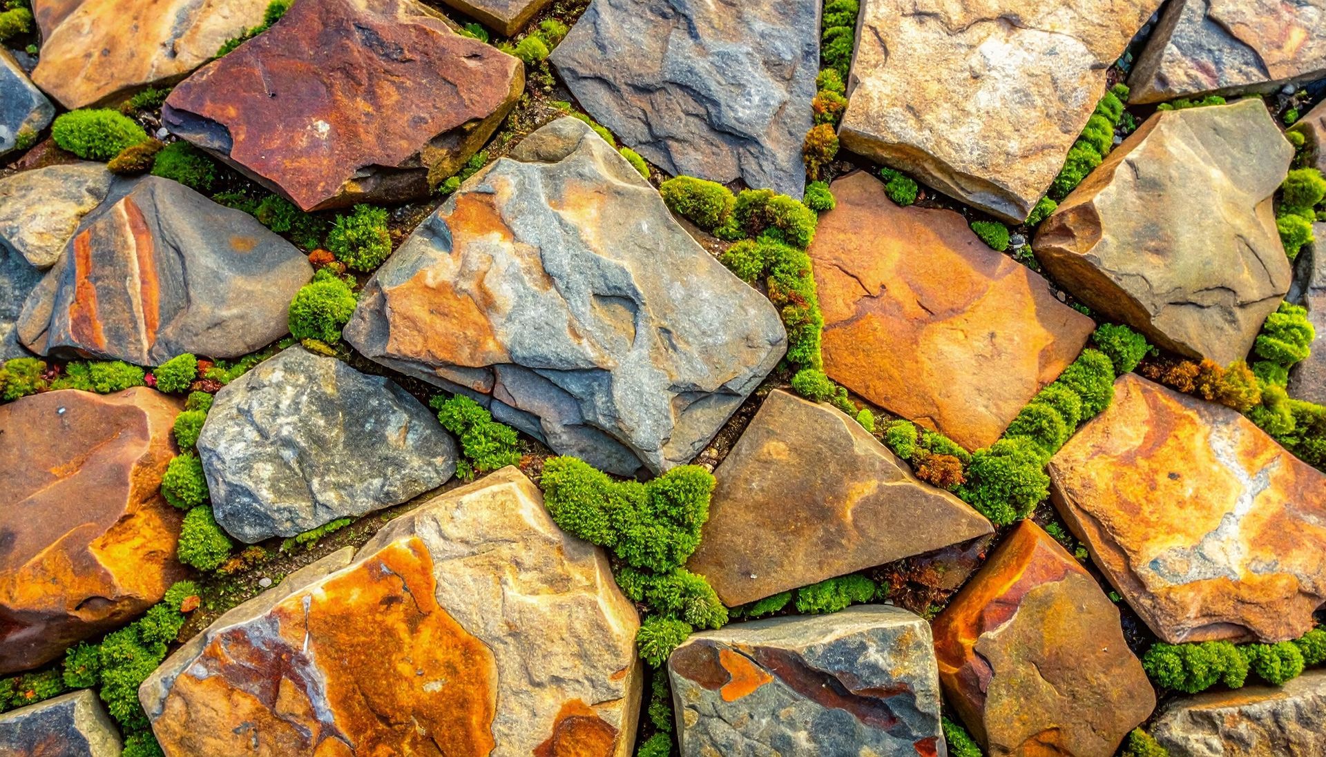 Rustic patio with brown, orange, grey, and green stone and moss-accented flagstone Rustic patio with brown, orange, grey, and green stone and moss-accented flagstone