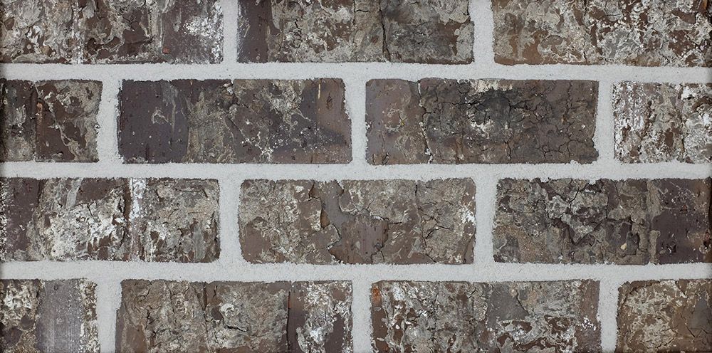 Close-up of a brick wall with gray, brown, and white colors.