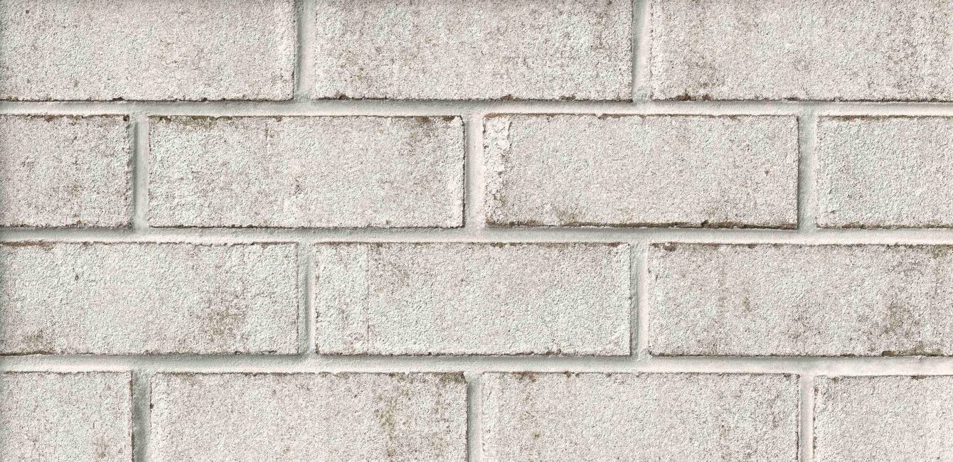 White brick wall with weathered texture.