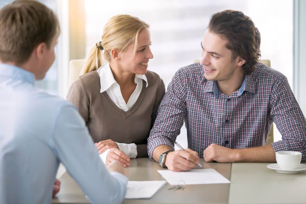 A Man and A Woman Are Sitting at A Table Talking to A Man — Marks Financial Group in Toowoomba City, QLD