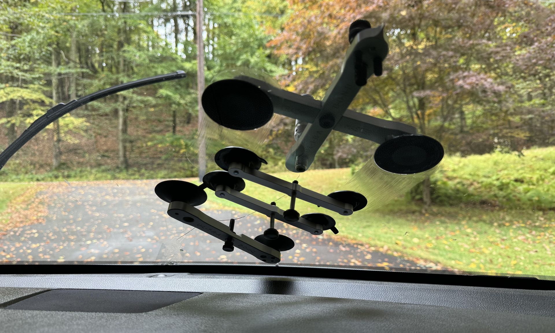 A close up of a windshield with a wiper on it.