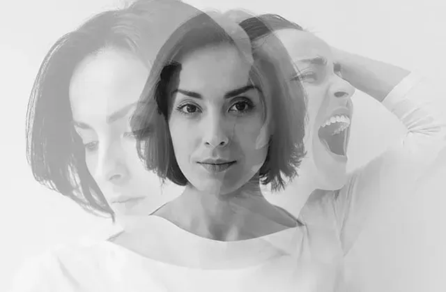 A black and white photo of a woman with multiple faces.