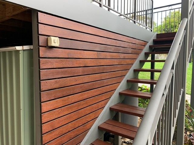 A set of wooden stairs leading up to a deck