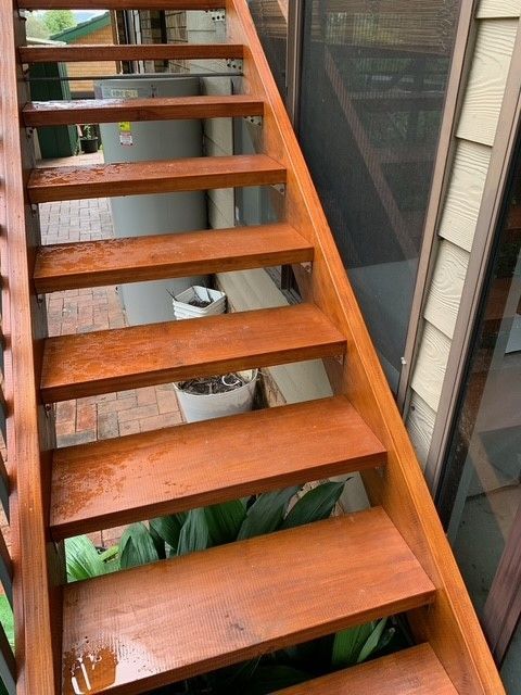 A set of wooden stairs leading up to a house.