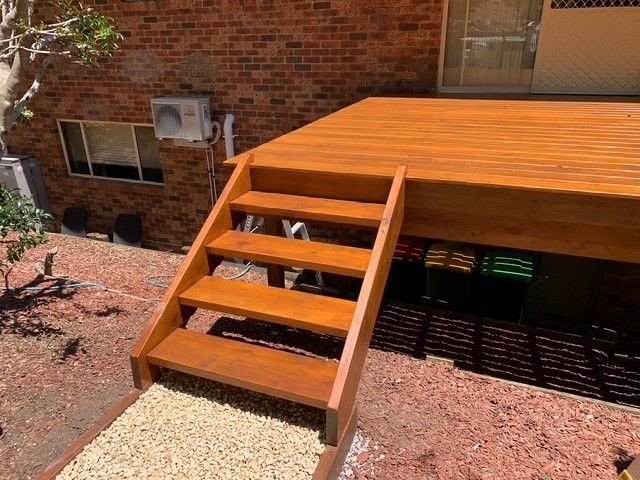 A wooden deck with stairs leading up to it
