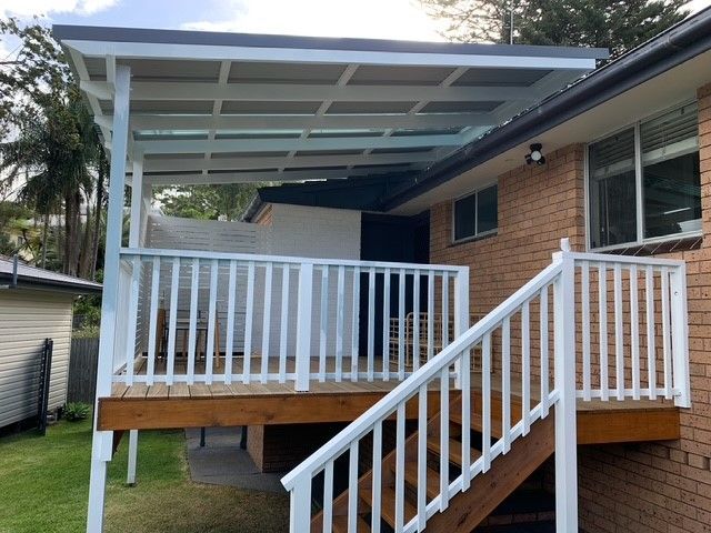 A house with a deck and stairs leading up to it