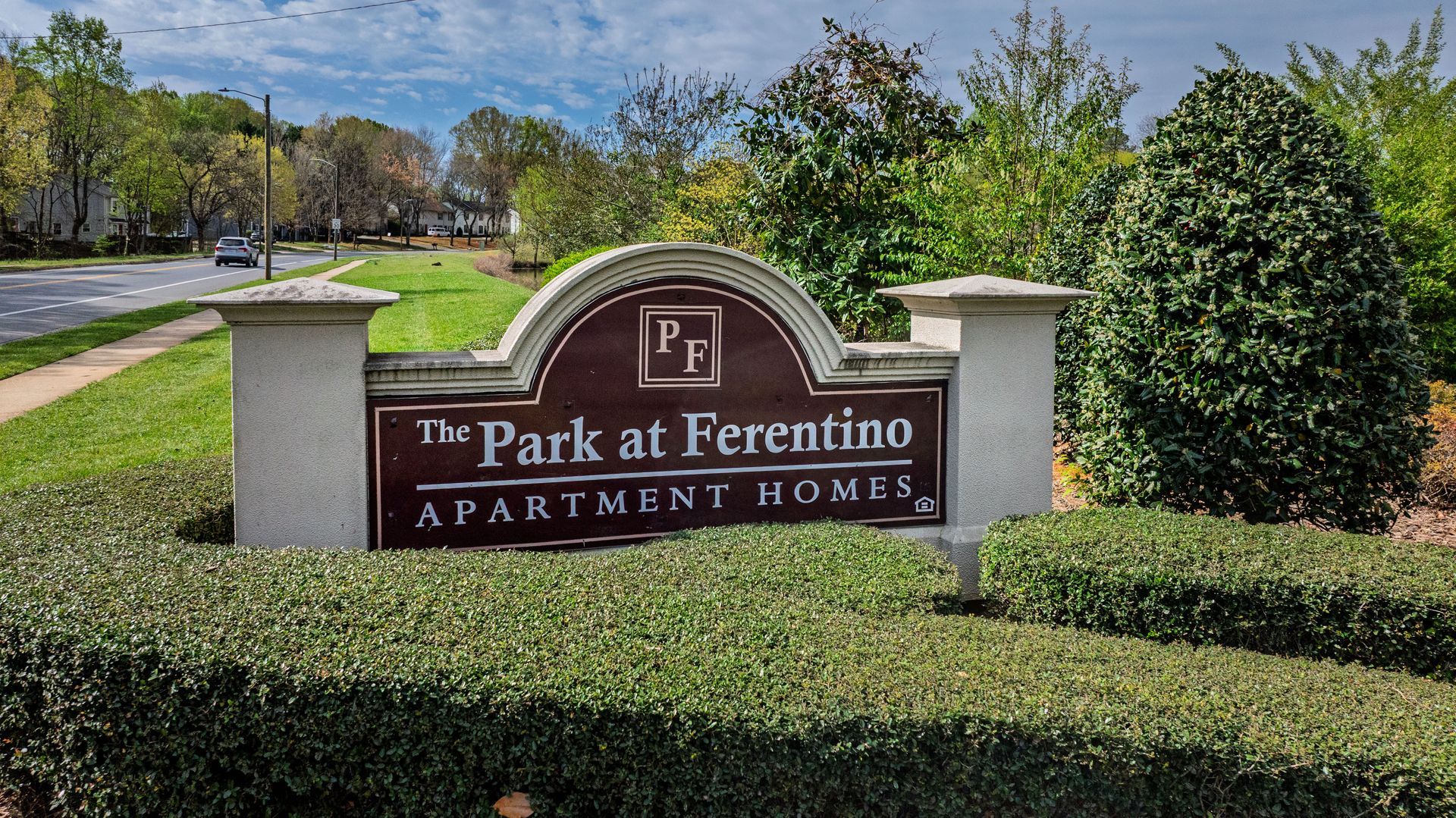 The Park at Freretino apartment homes sign in a landscaped residential entrance