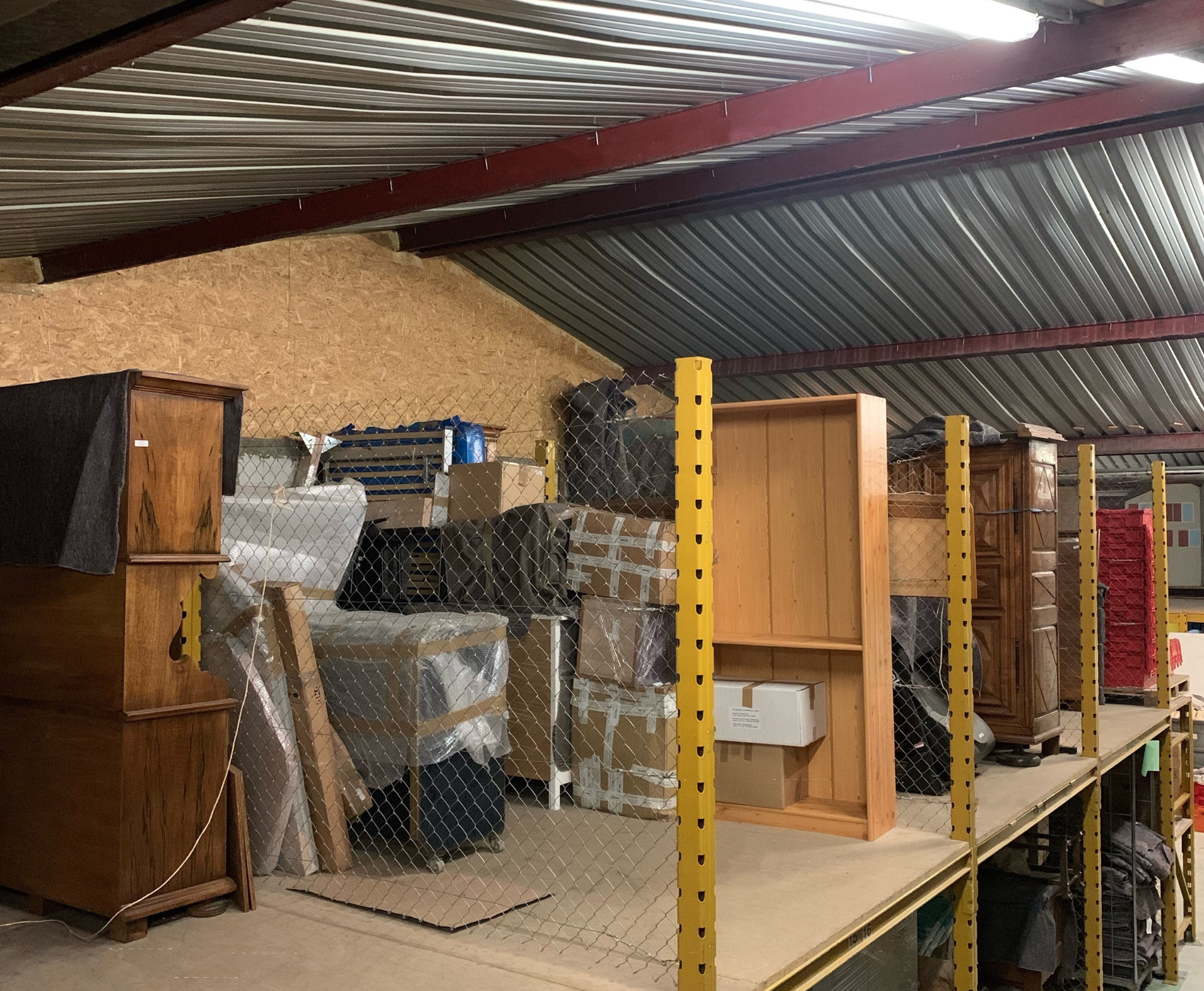 Un entrepôt rempli de beaucoup de meubles et de cartons