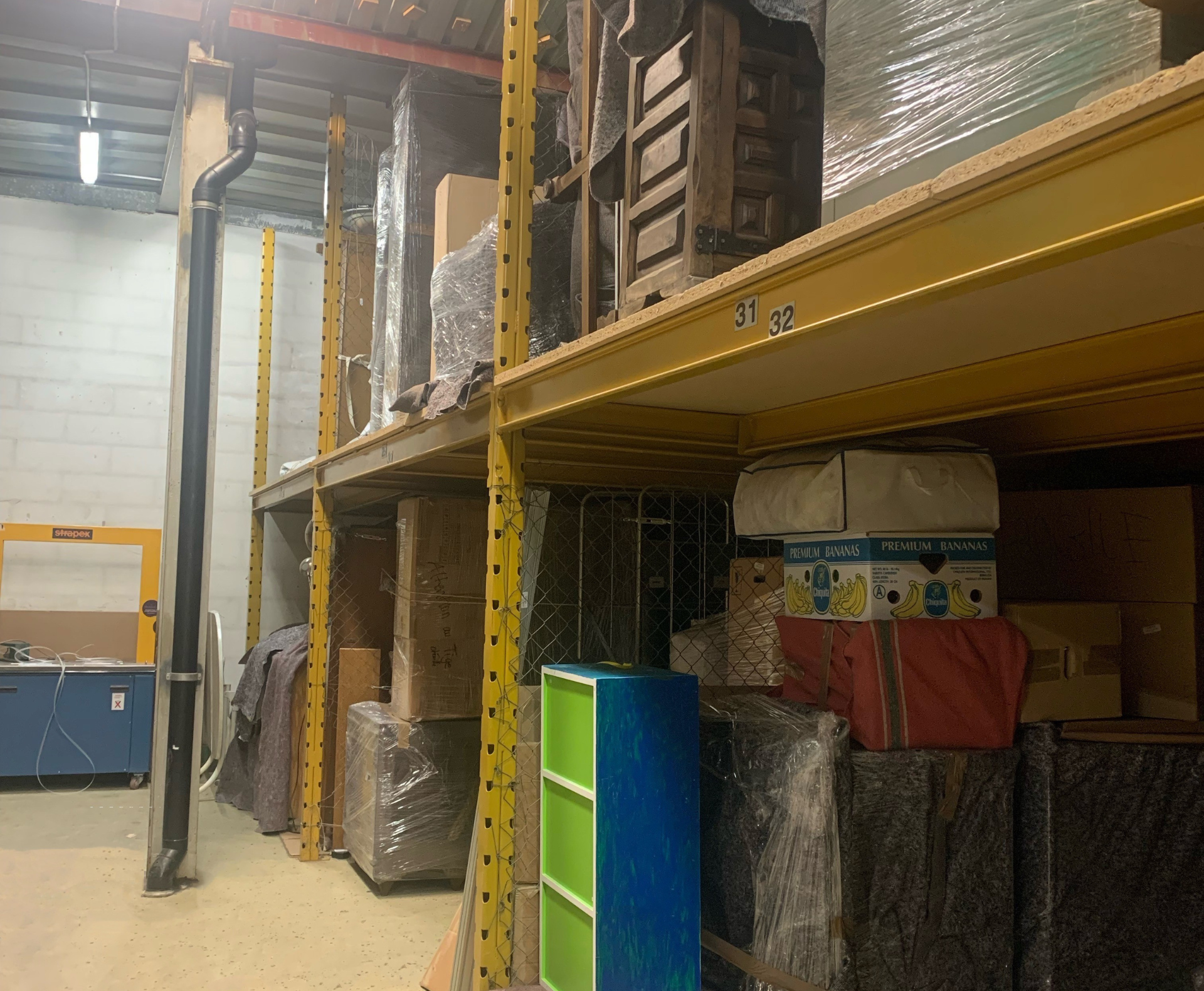 Un entrepôt rempli de nombreuses boîtes et étagères.