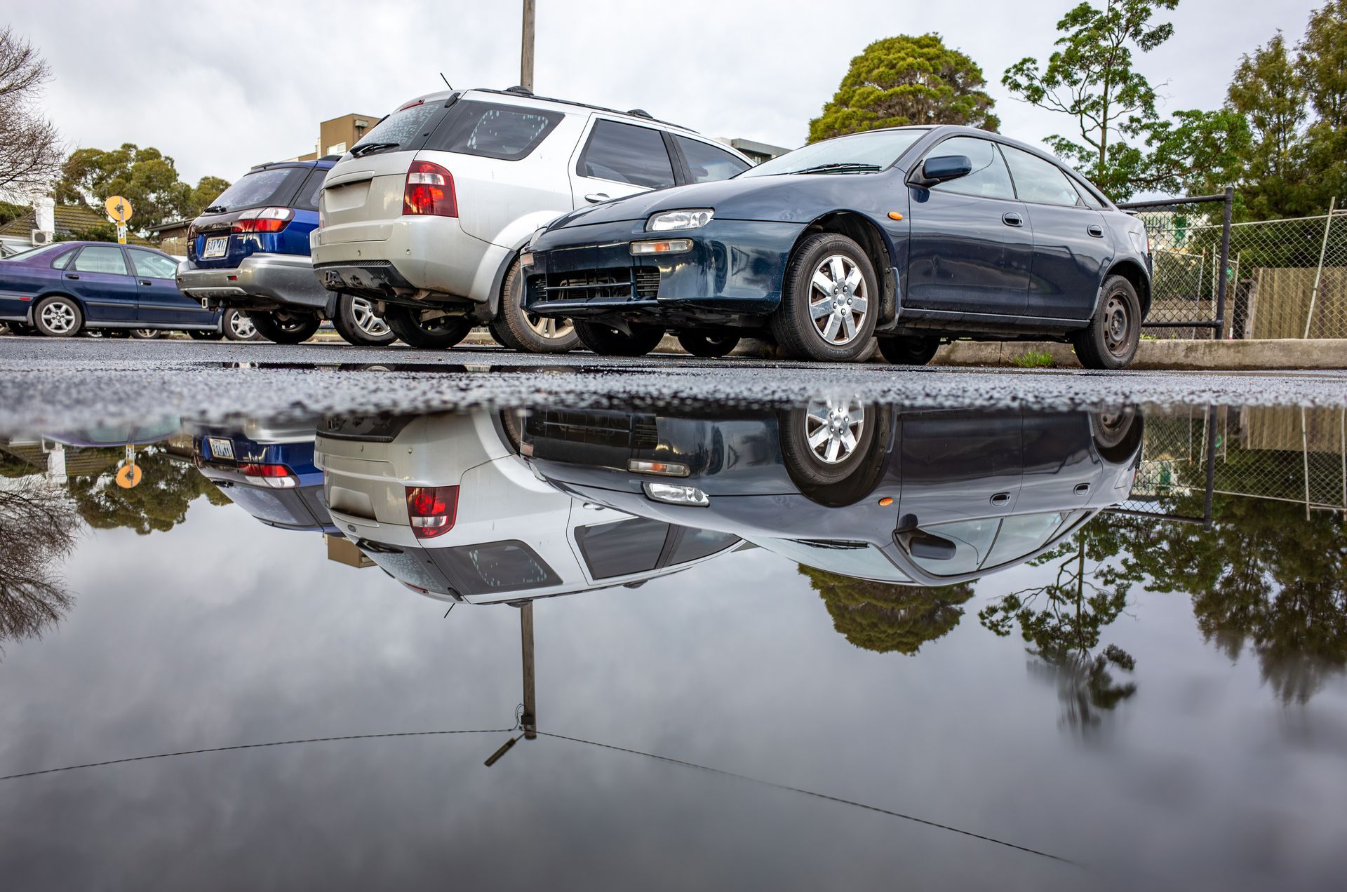 Puddle on asphalt calling for parking lot paving service