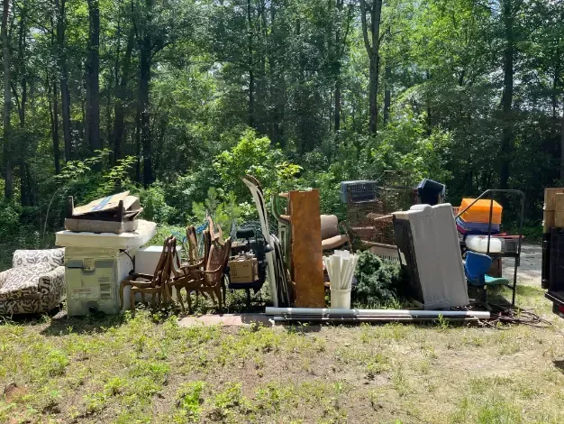 a pile of junk is sitting on top of a lush green field .