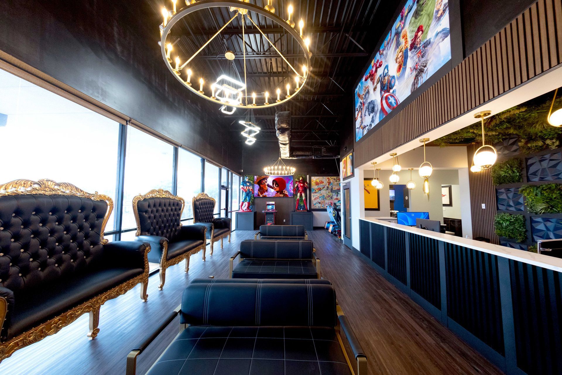 Modern lounge bar interior with black tufted seating, wood floors, chandeliers, and a long counter