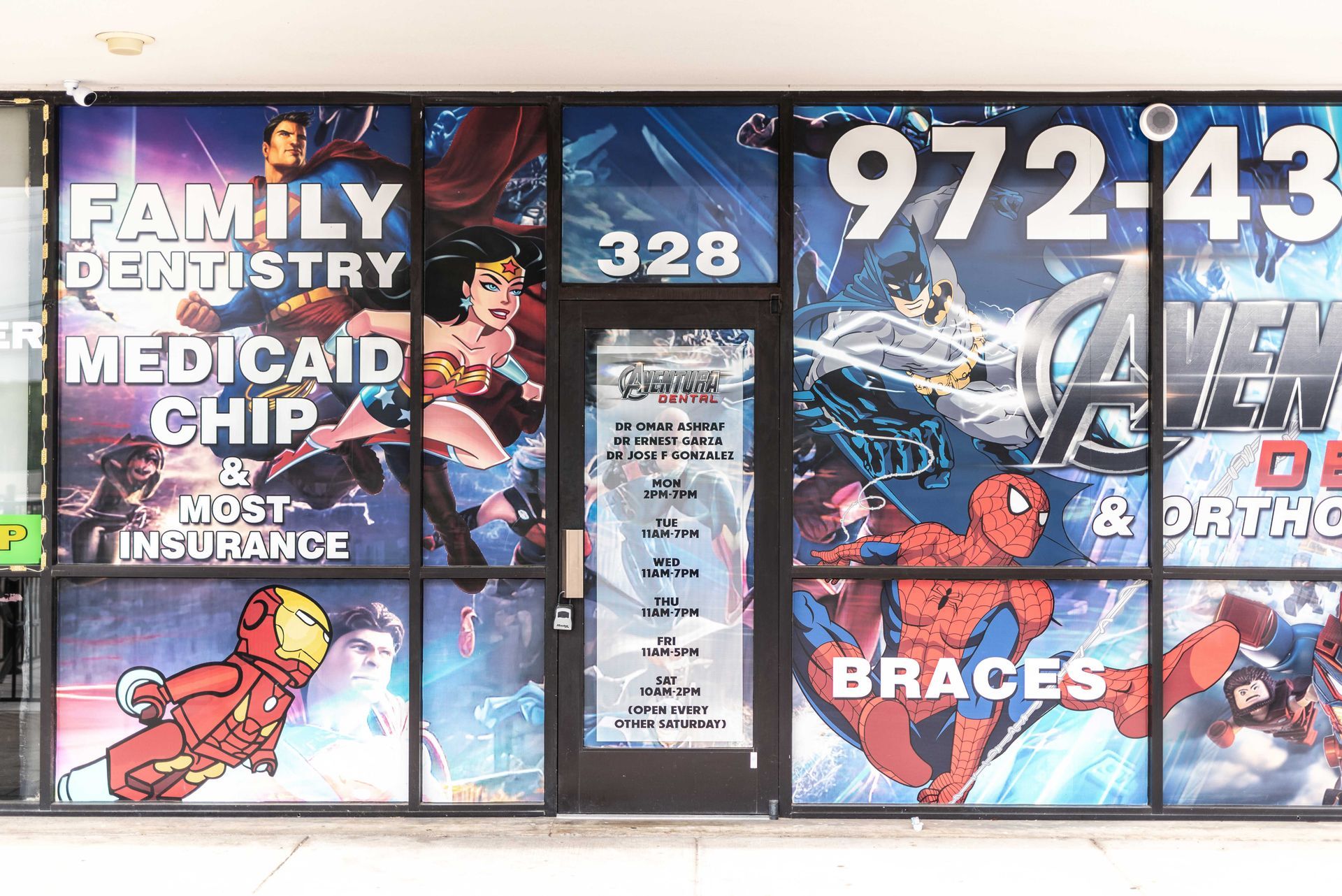 Medicaid and CHIP insurance office window with superhero and family-themed graphics