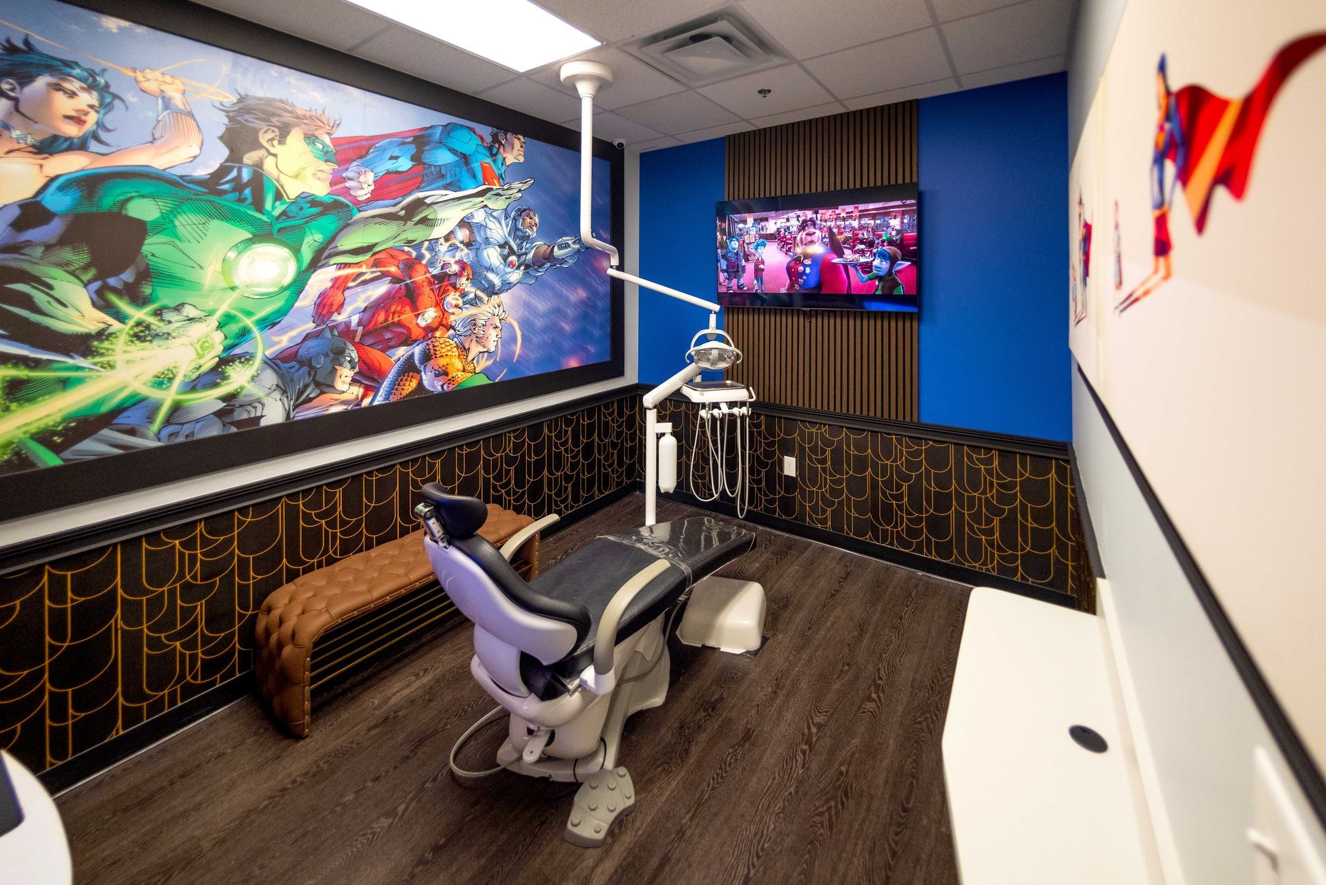 Modern gaming room with a chair, large colorful wall mural, and multiple screens for viewing games