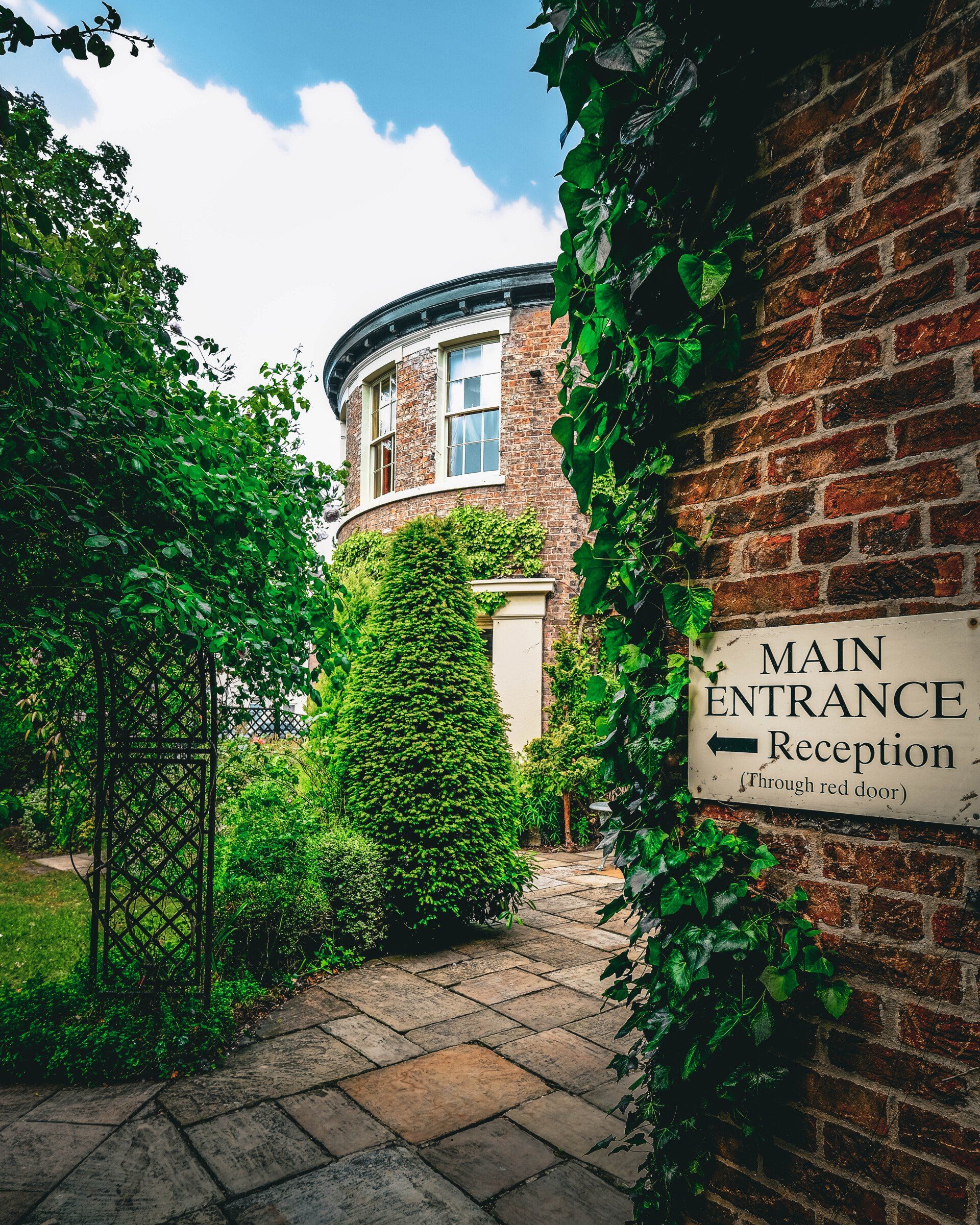 A brick wall with a sign on it that says main entrance reception