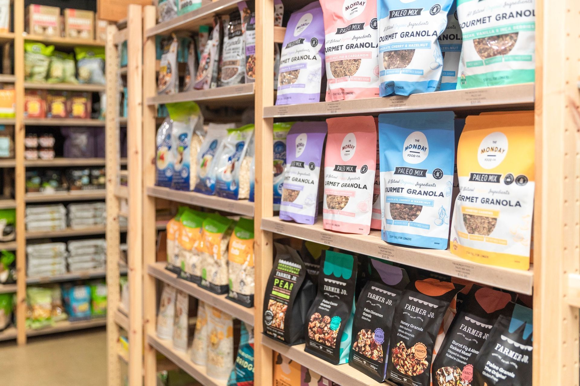 Shelves in a Store Stocked With Colorful Bags of Granola — The Real Grocer In Golden Beach, QLD