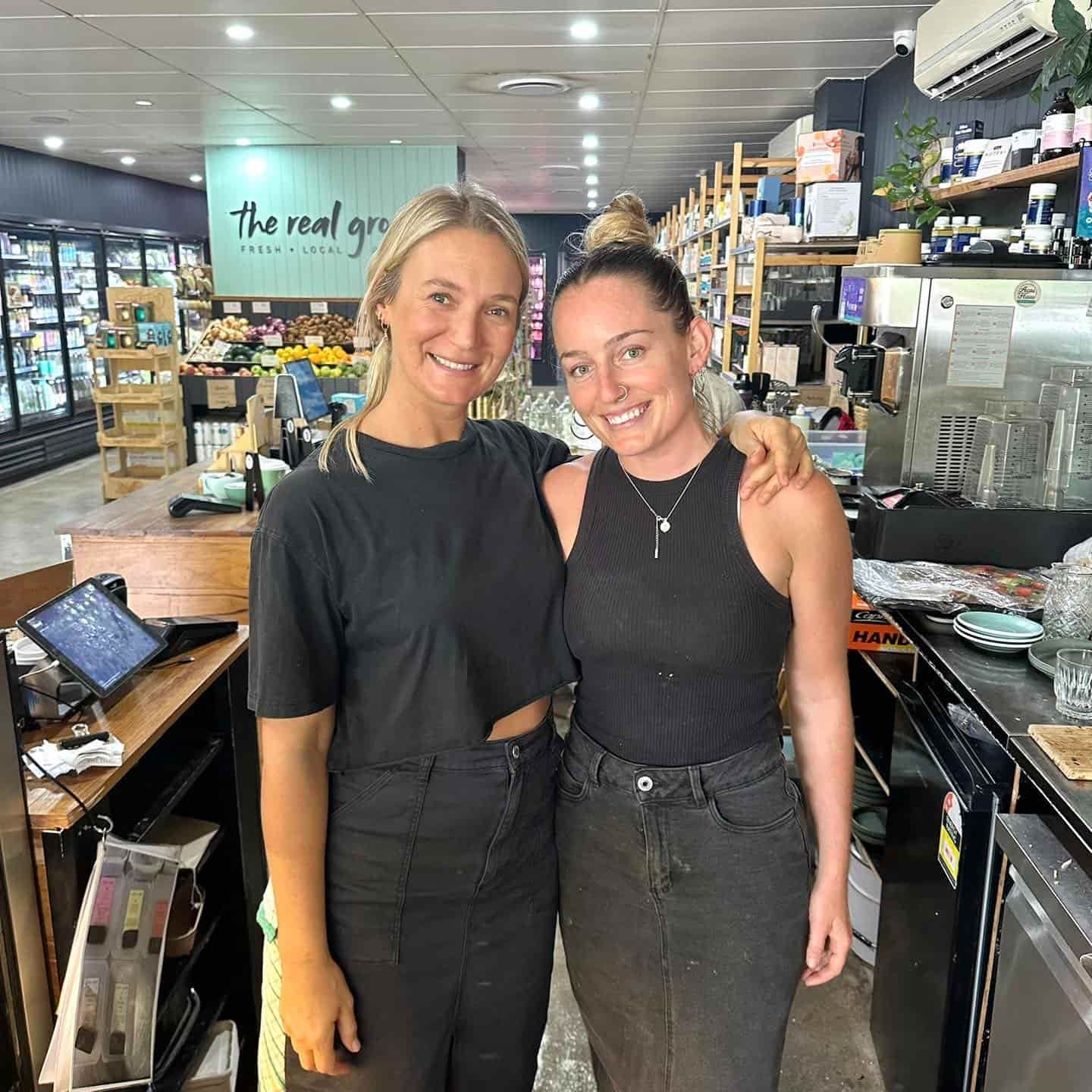 Two Women Are Posing For A Picture In A Grocery Store — The Real Grocer In Golden Beach, QLD