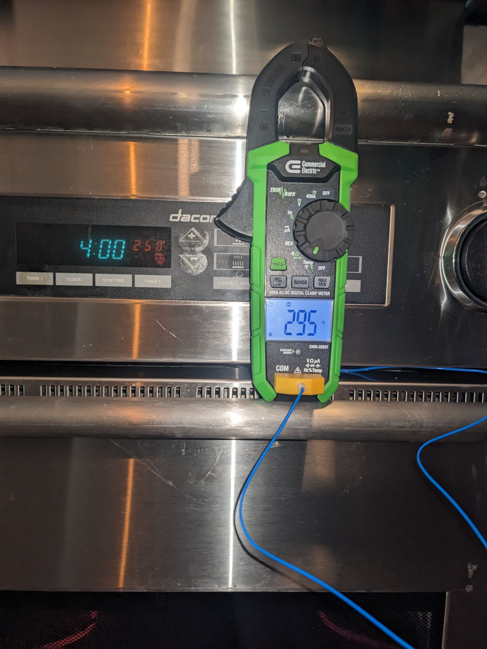 Clip-on thermometer on a stainless steel oven showing 205°F, with another display reading 410°F nearby.