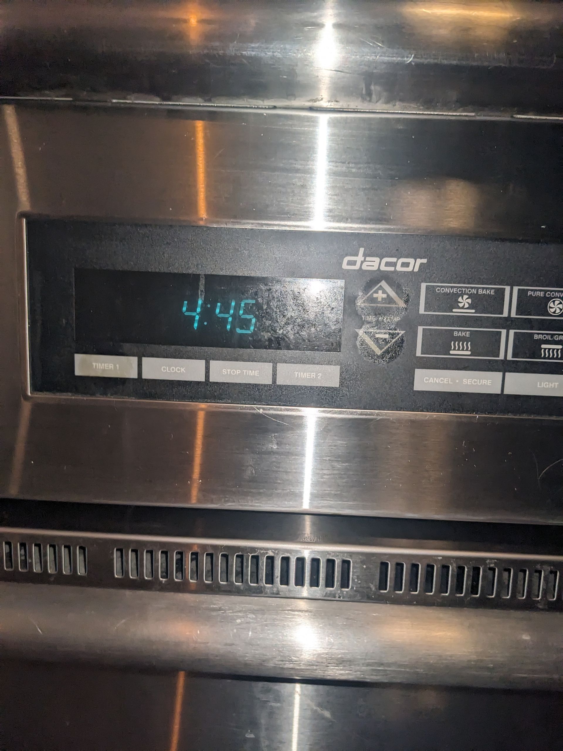 Stainless steel Dacor oven control panel displaying 4:45 on the digital clock