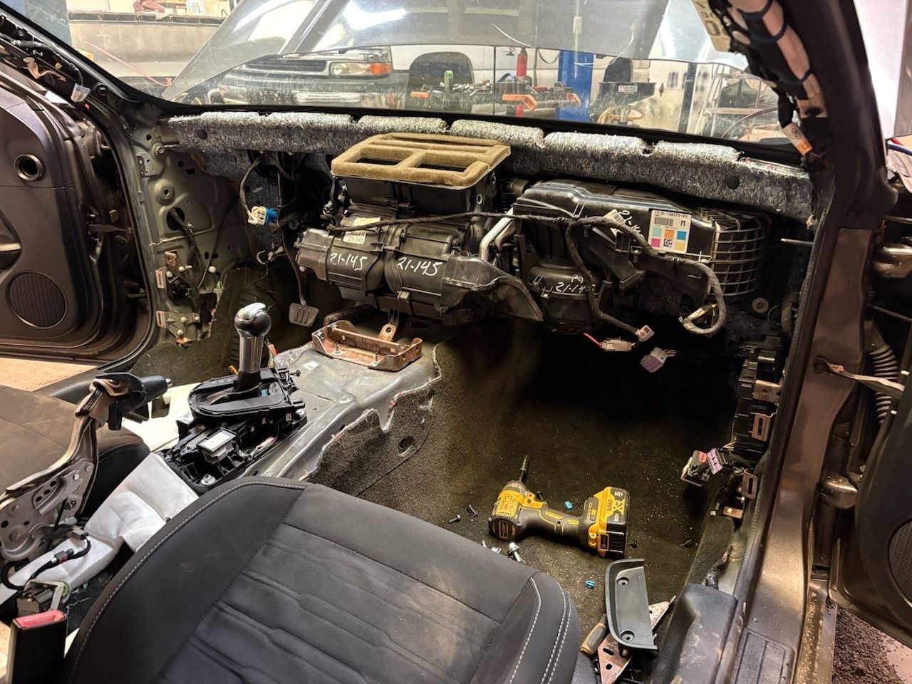2019 Dodge Challenger with the dashboard and seats partially removed for an automotive repair.