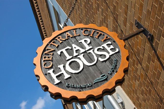 Tap House — Kalamazoo, MI— Sign Center Central City Tap House sign on brick building, circular with brown and white lettering.