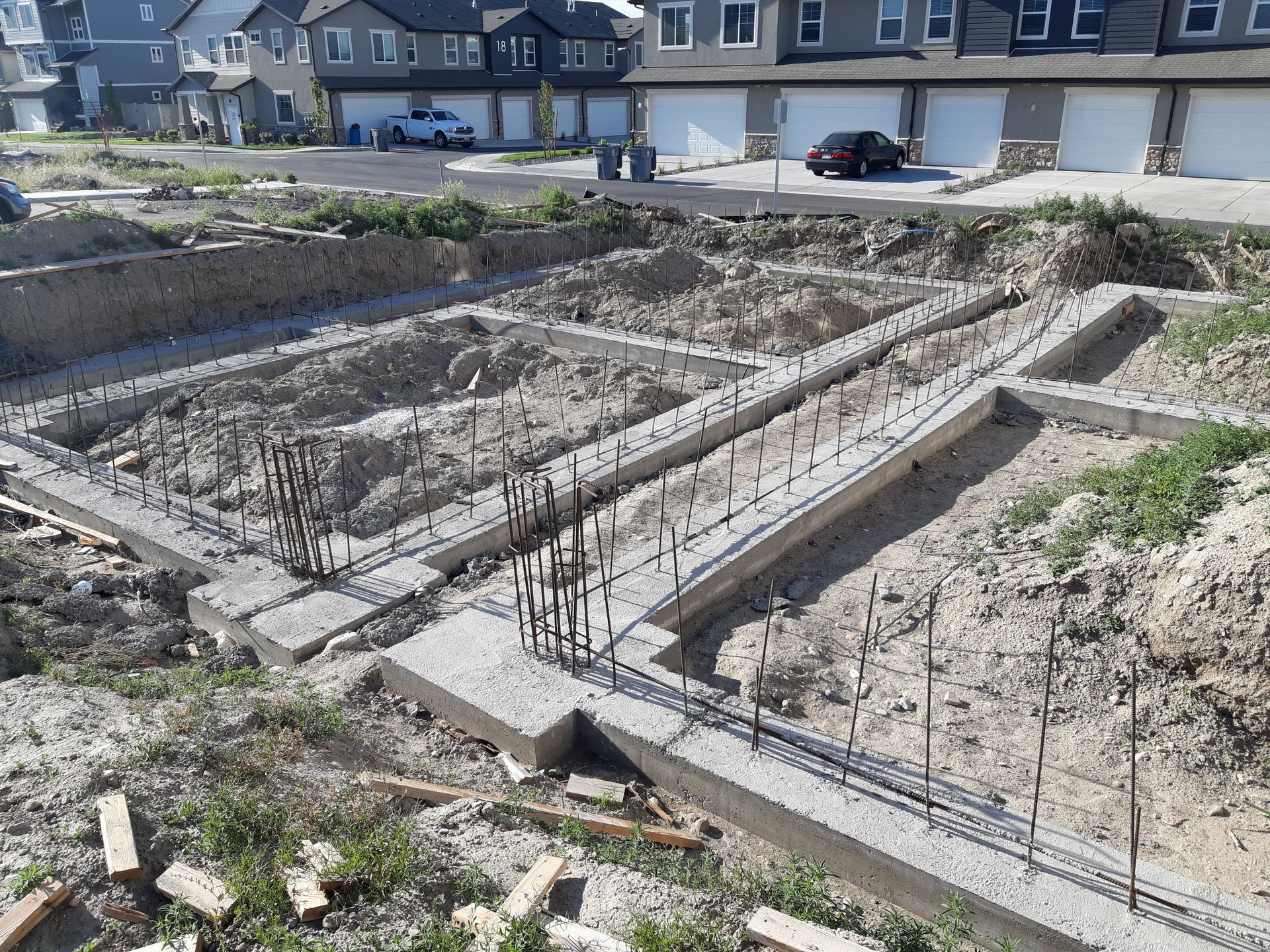 A concrete foundation is being built in a residential area.