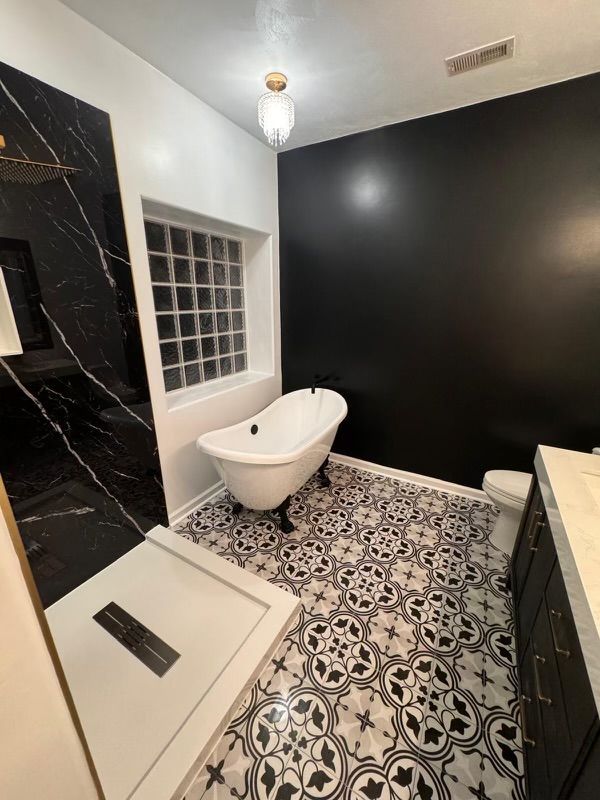 A bathroom with a claw foot tub and a walk in shower.