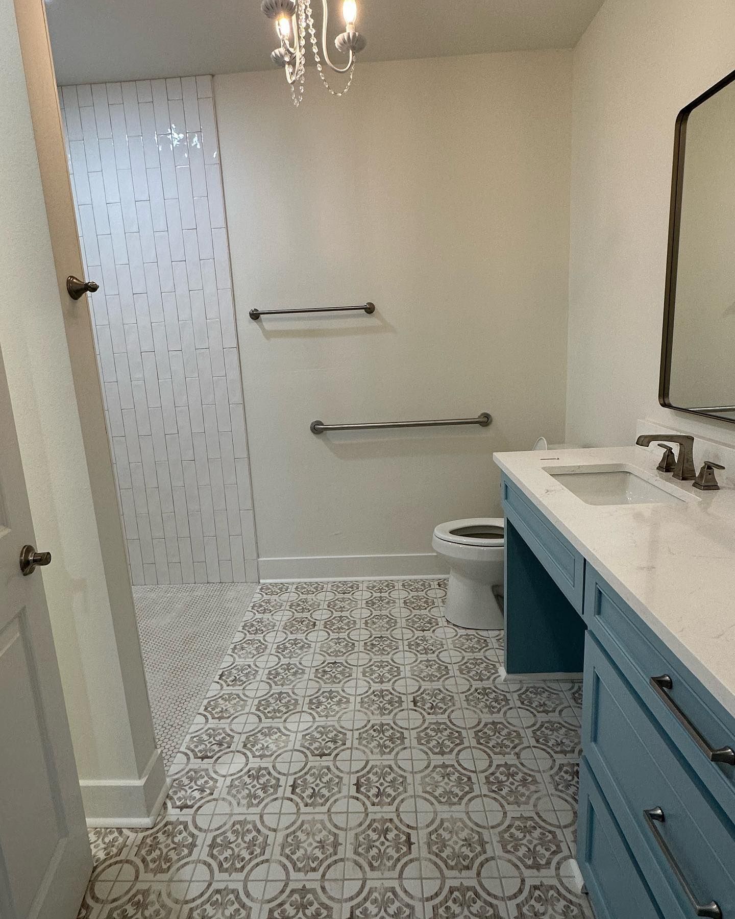 A bathroom with a toilet , sink and mirror.