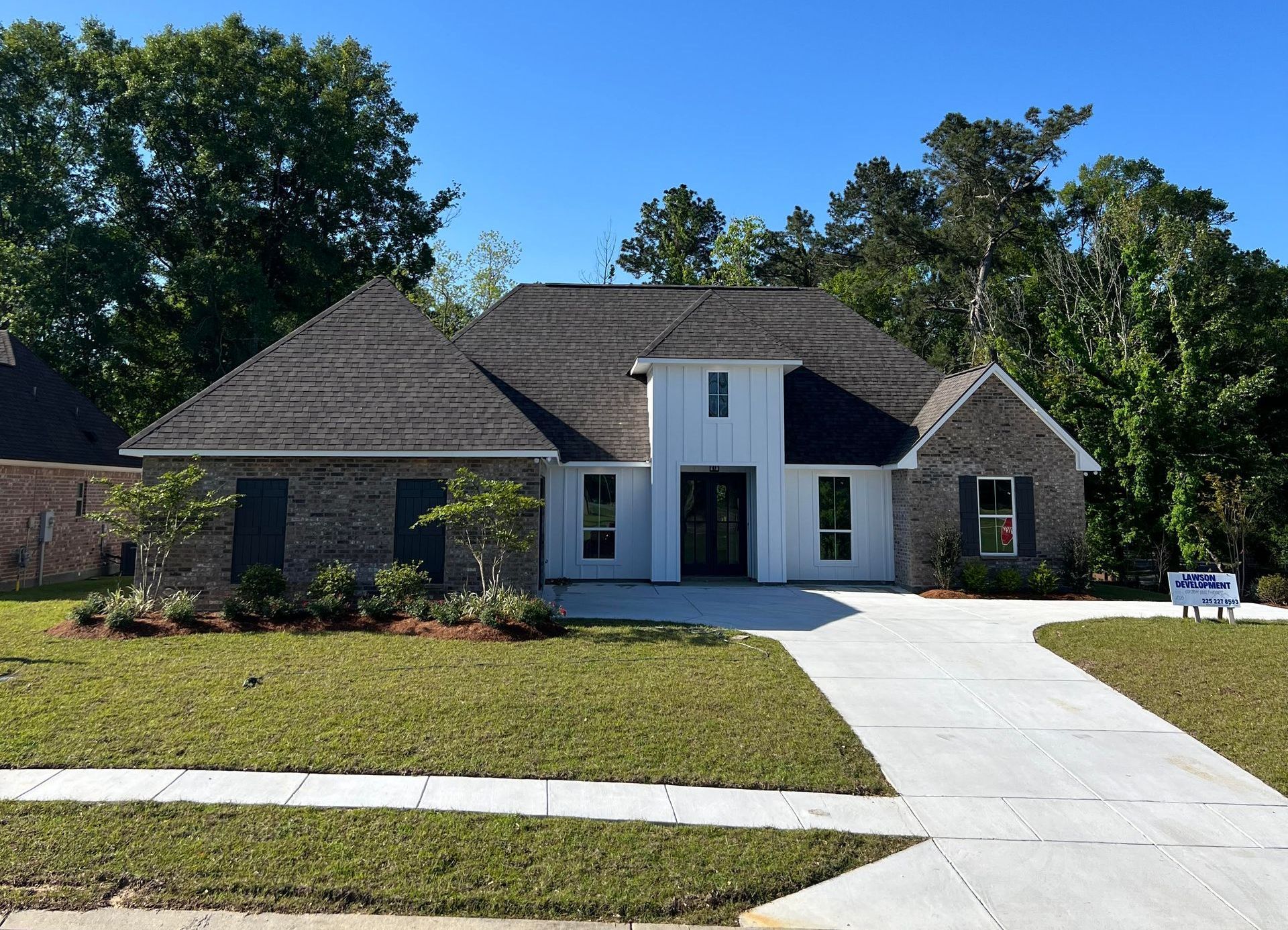 A large brick house with a gray roof is for sale