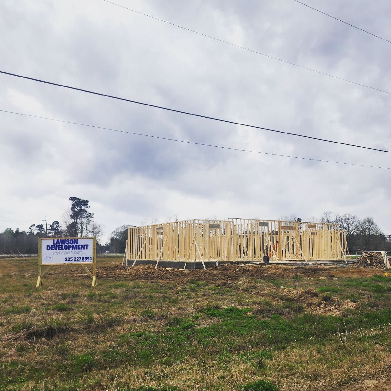 A house is being built in the middle of a grassy field