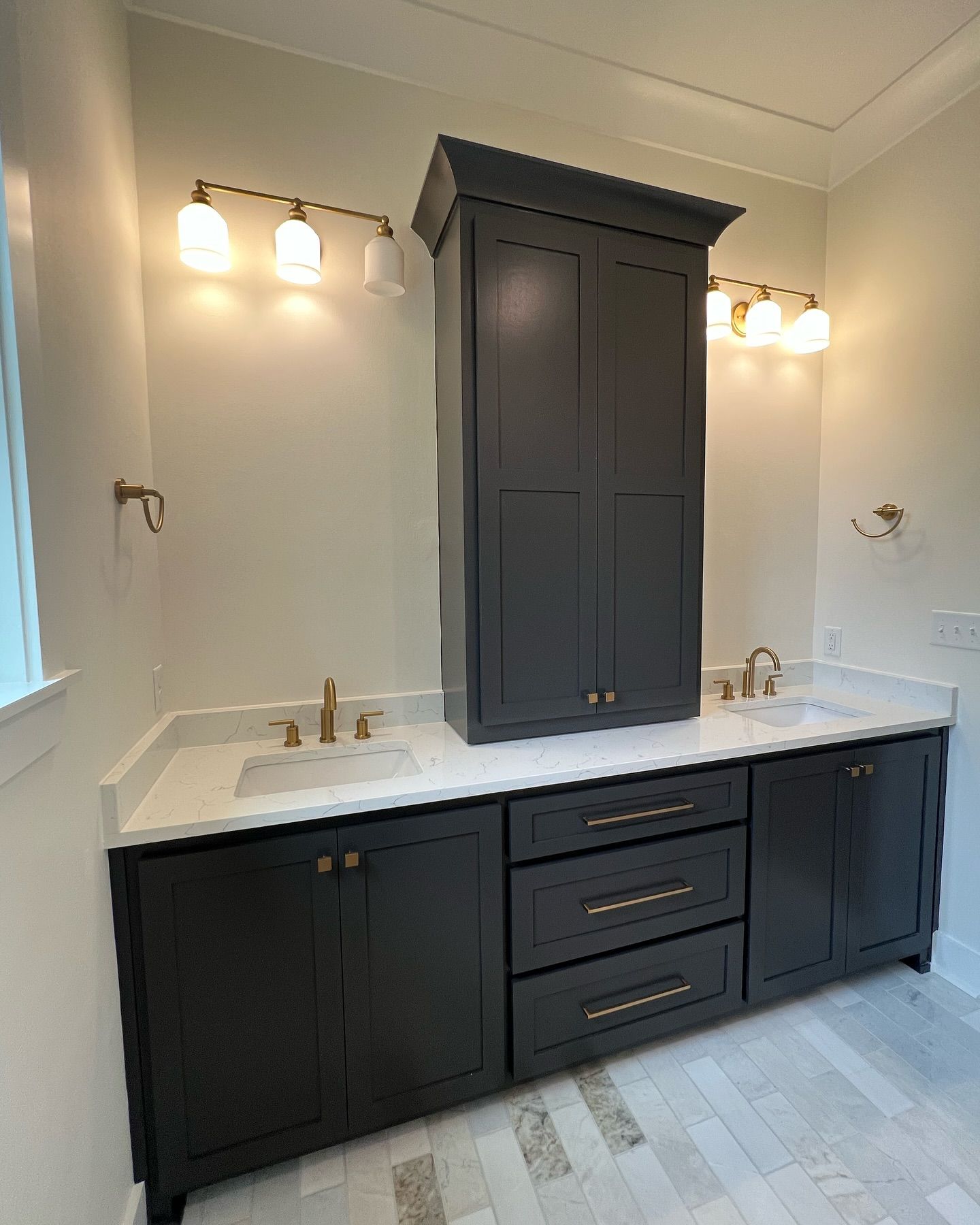 A bathroom with two sinks and a large cabinet