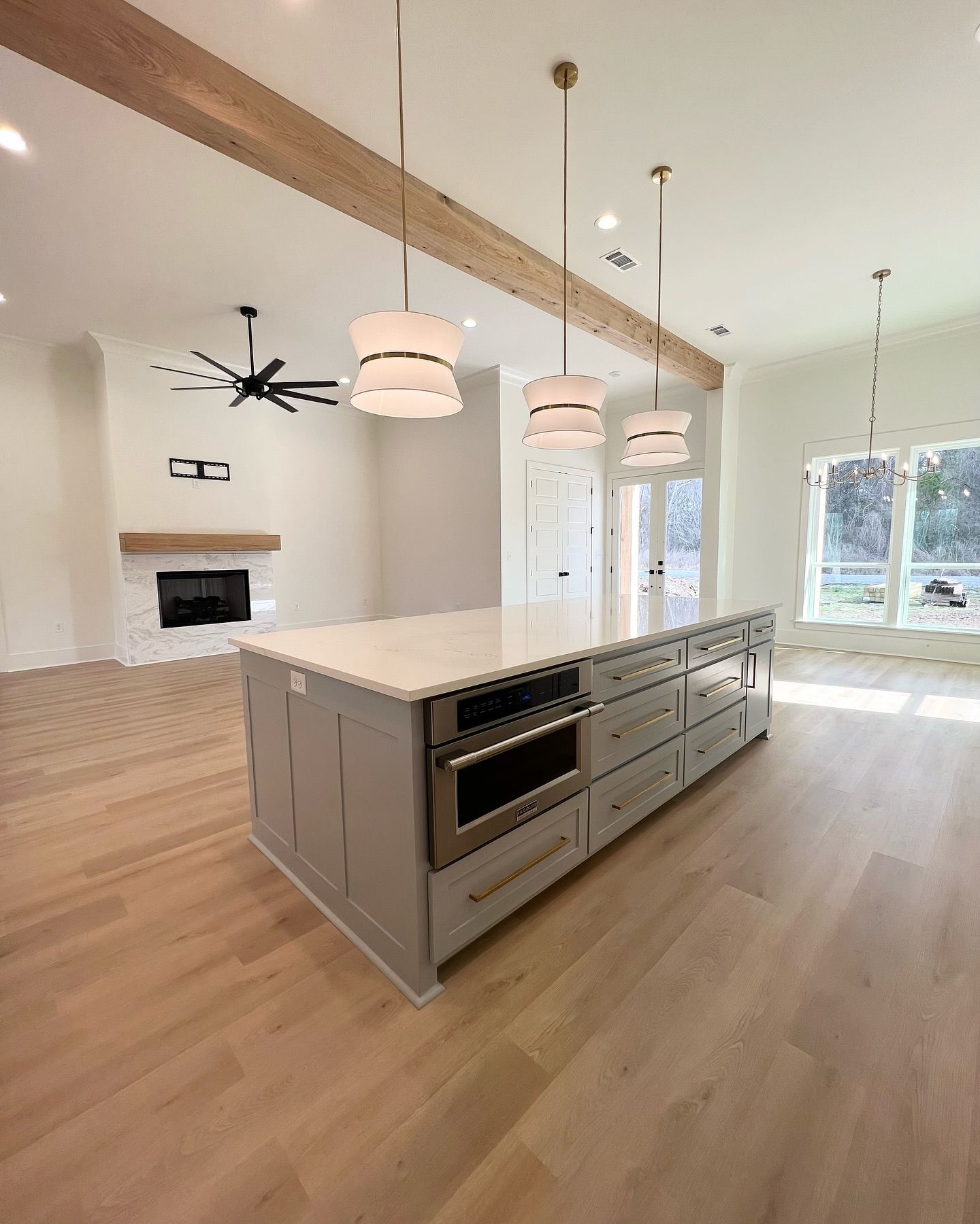A kitchen with a large island and stainless steel appliances