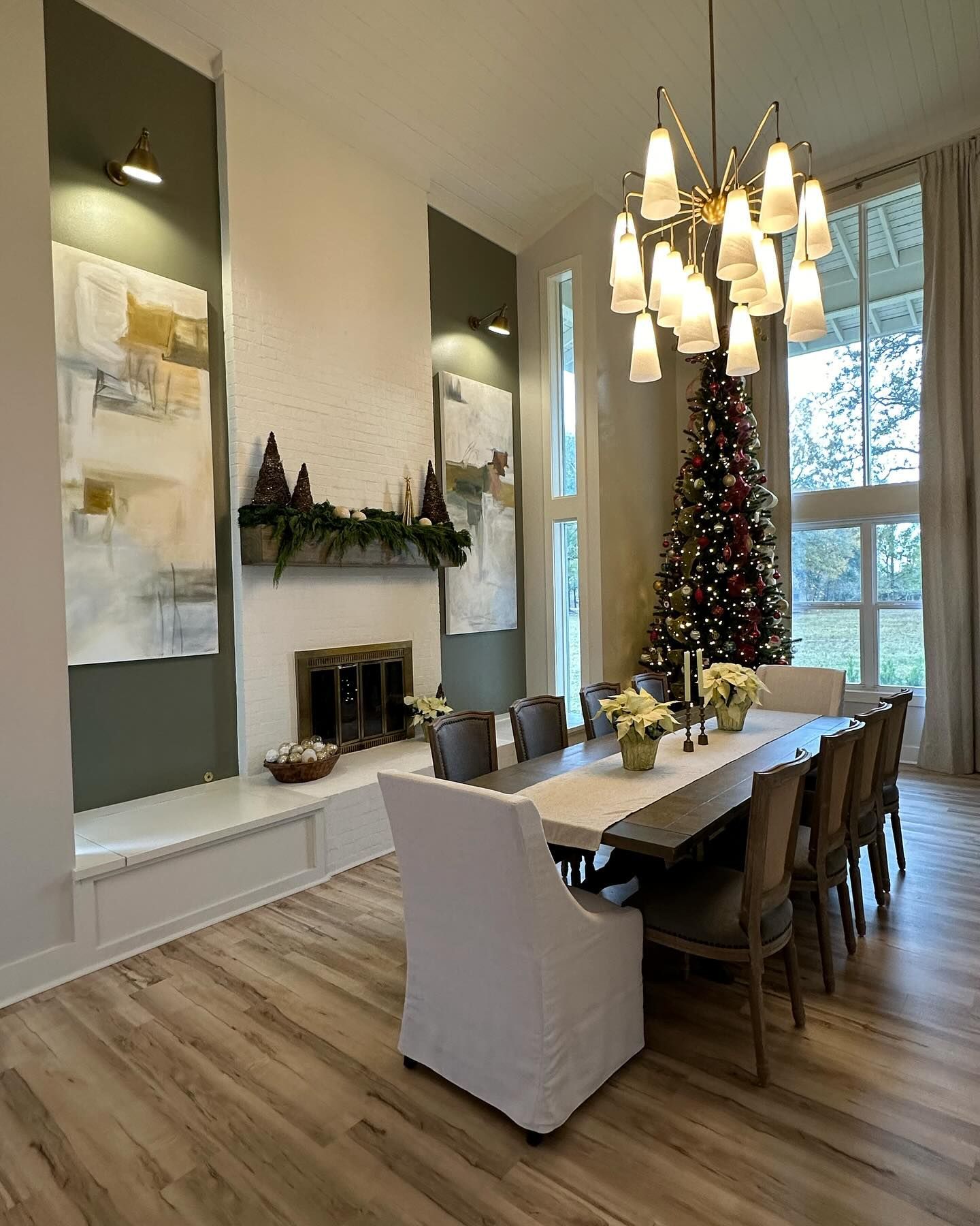 A dining room with a table and chairs and a christmas tree