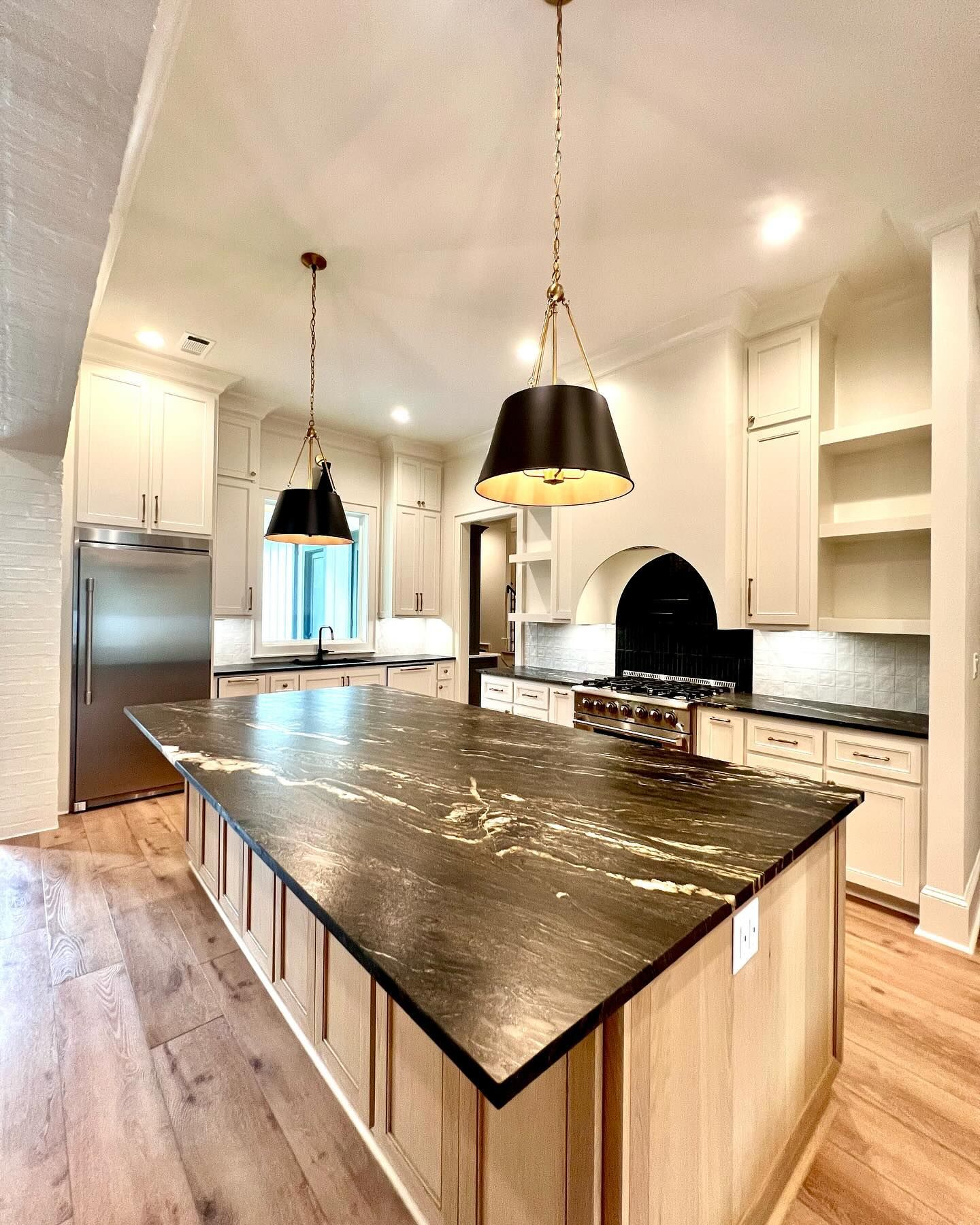 There is a large island in the middle of the kitchen.