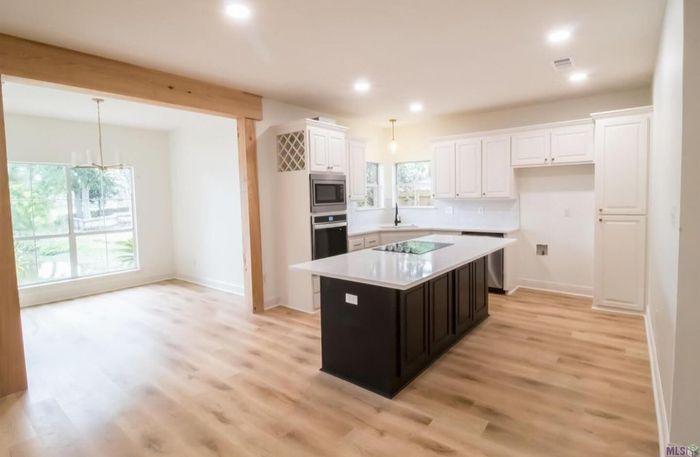 A kitchen with a large island in the middle of the room.