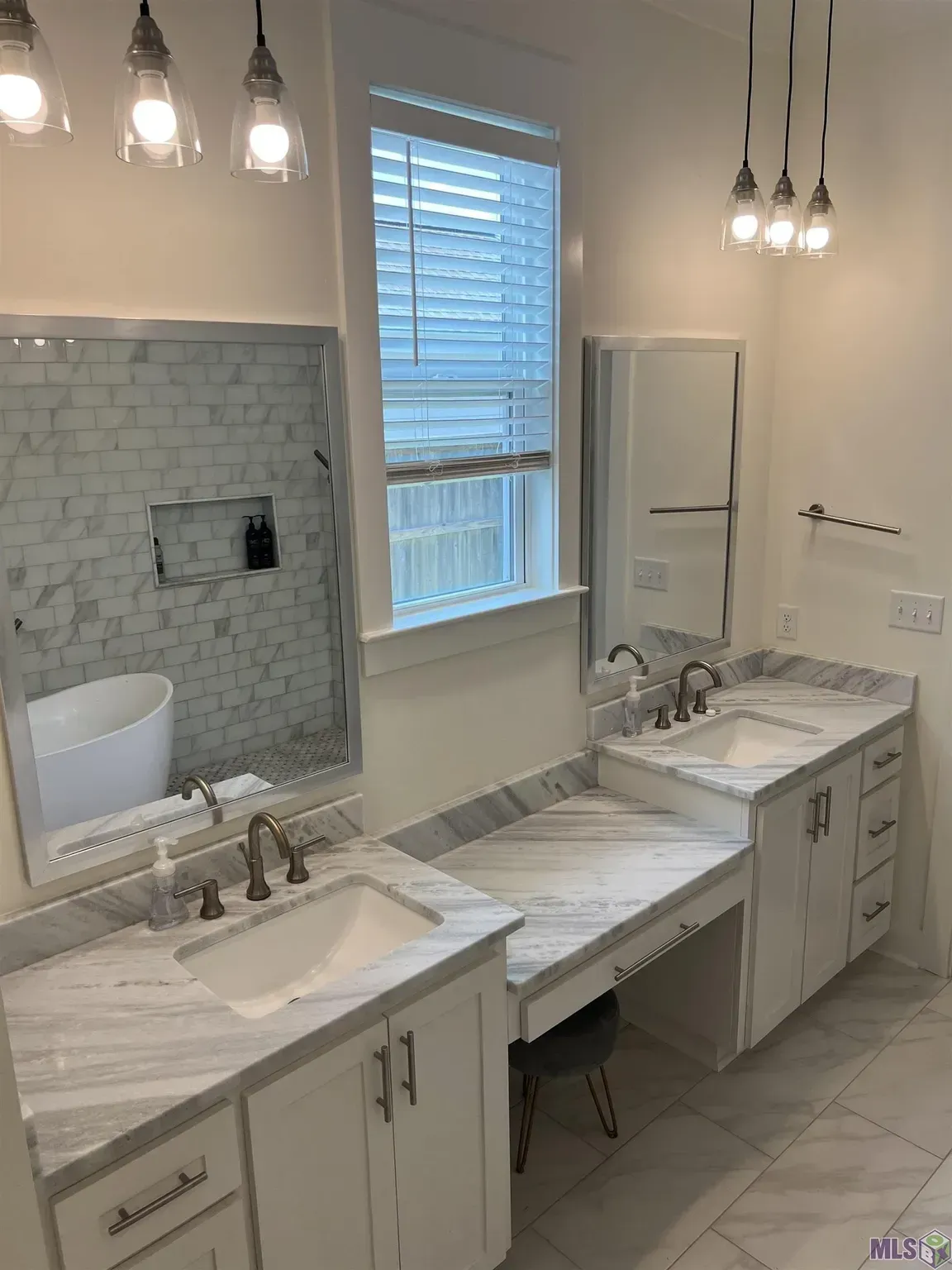 A bathroom with two sinks and a large mirror.