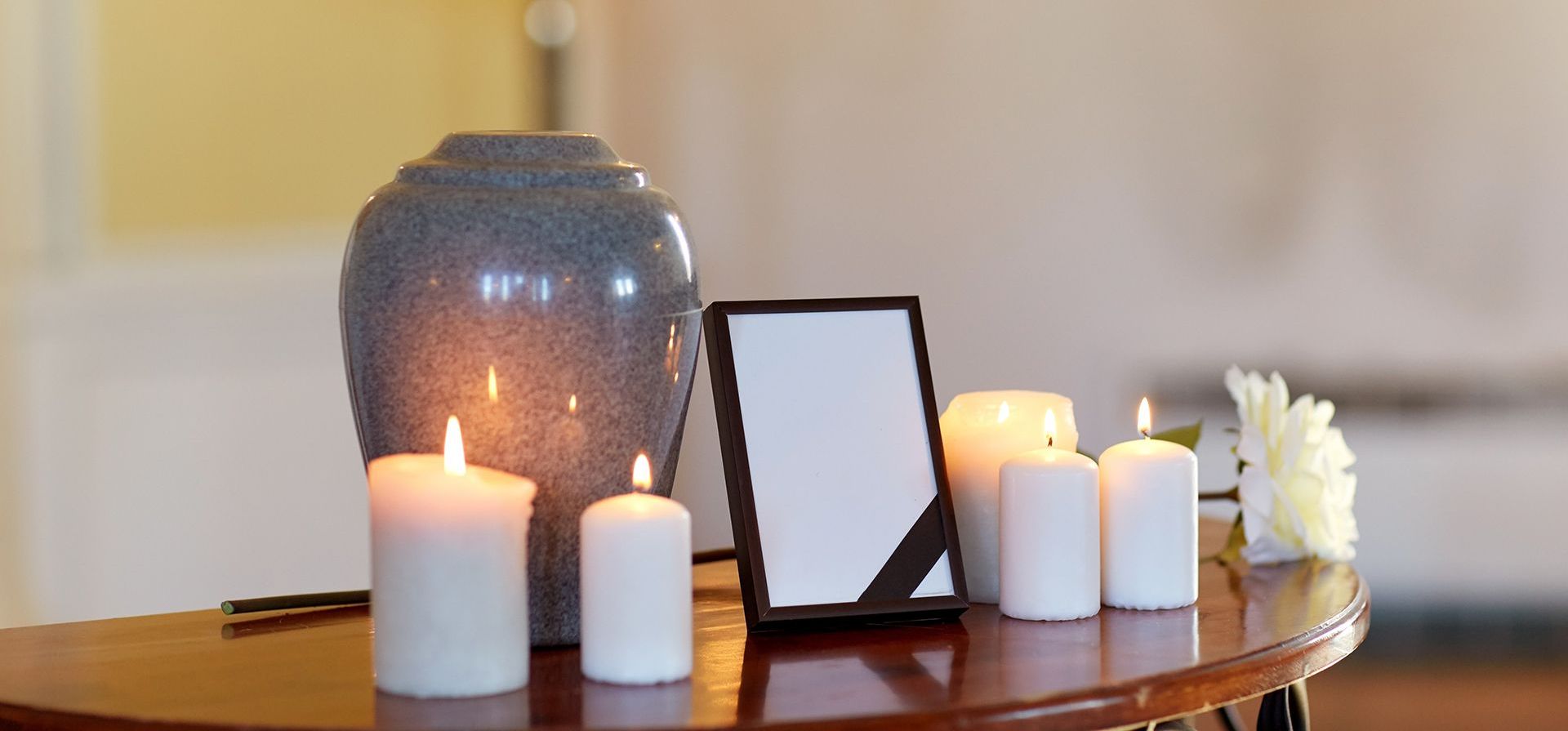 urn with candles and photo frame
