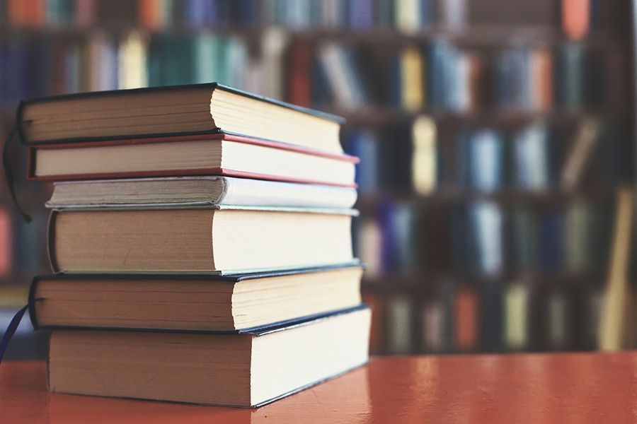 A stack of books tied together with a string