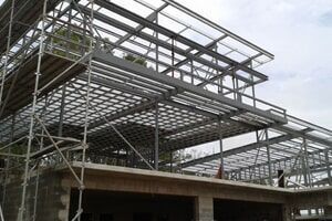 a large metal structure is being built on top of a building .