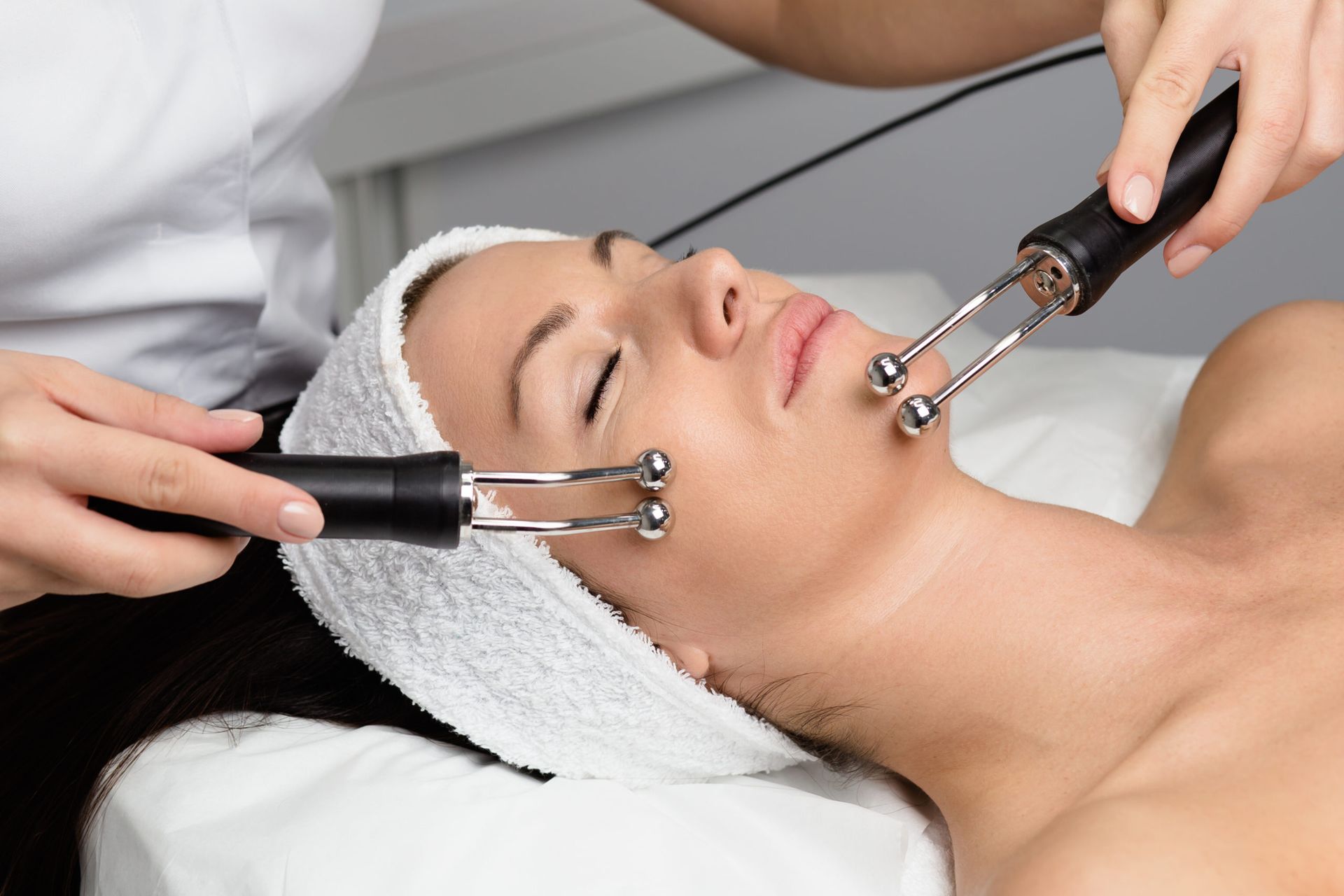 A woman is getting a facial treatment at a spa.
