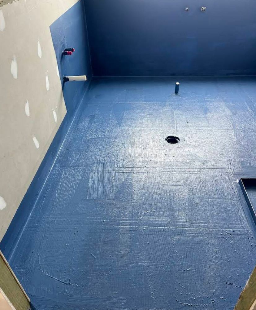 Blue-painted Bathroom Floor and Walls in a Construction Phase — Consider it Sealed Waterproofing in Wyong, NSW