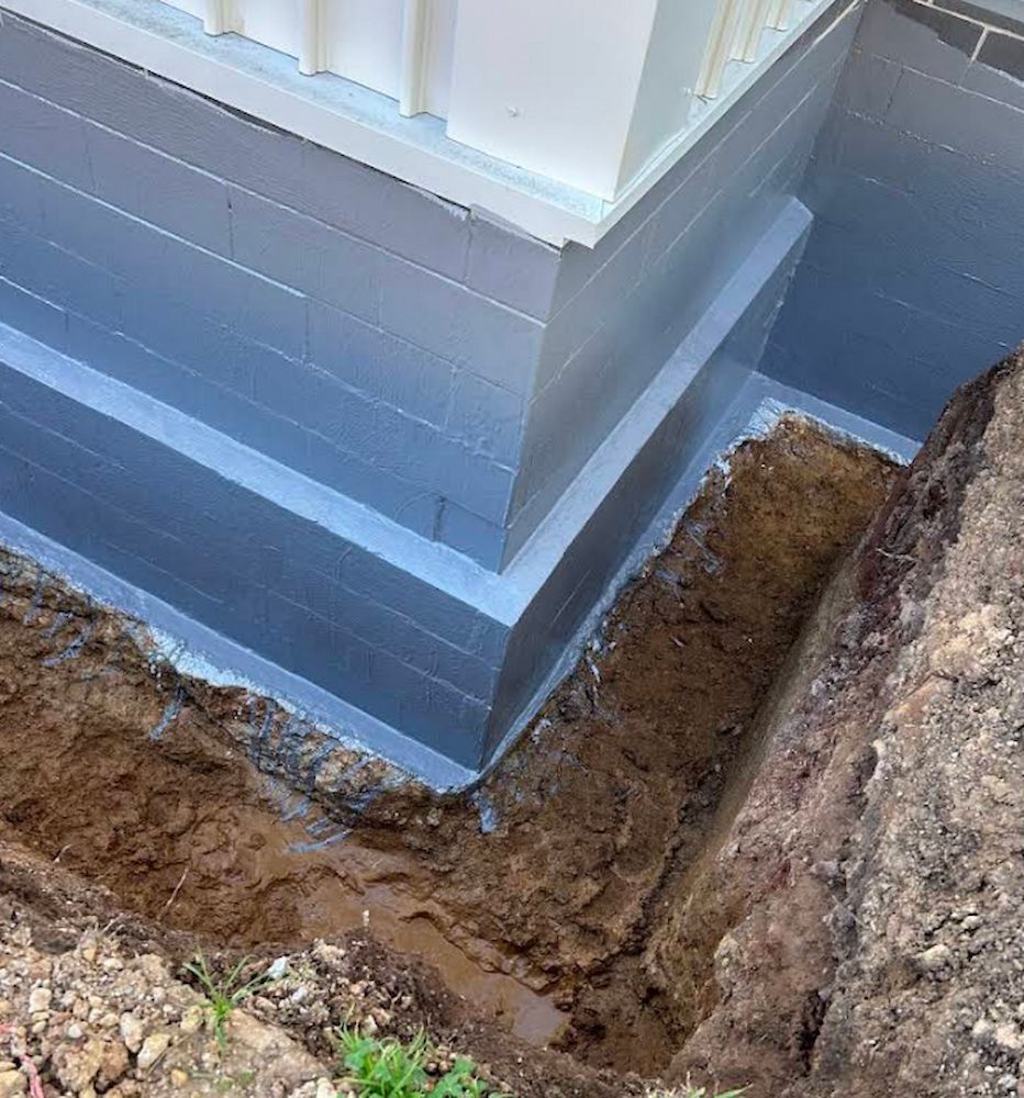 Foundation of a Building Coated With a Gray Sealant — Consider It Sealed Waterproofing in Central Coast, NSW