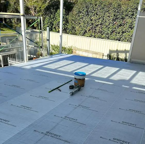 Rooftop Under Construction With Gray Waterproof Membrane Installed — Consider it Sealed Waterproofing in Wyong, NSW