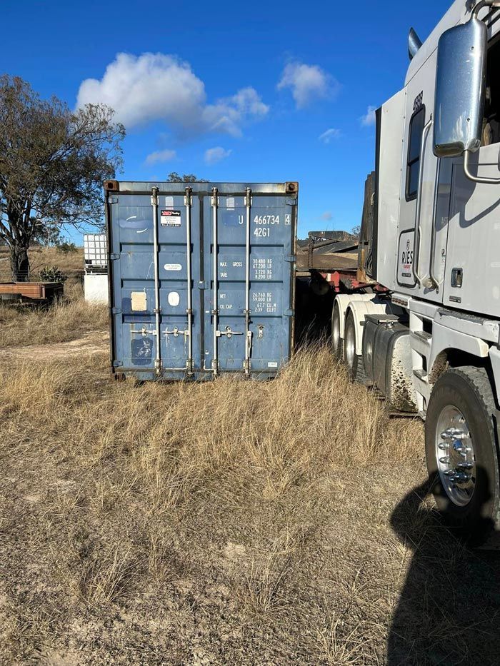 High Cube Container Next To A Truck — Ries Trucking in Gowrie Mountain, QLD