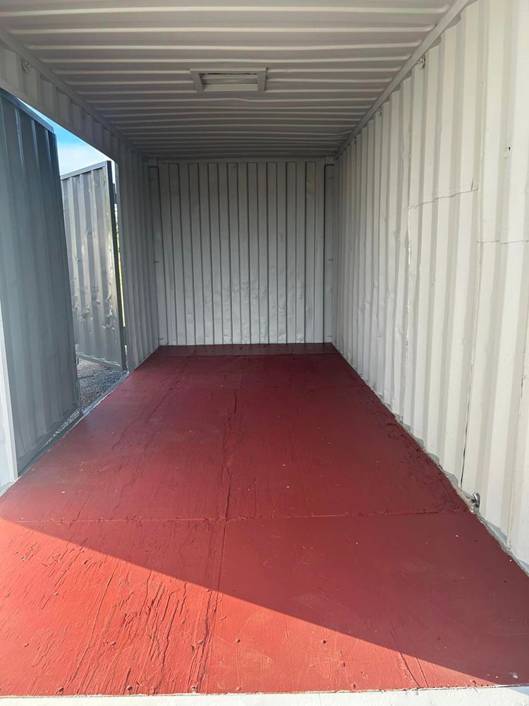 The Inside Of A Shipping Container With A Red Floor — Ries Trucking in Gowrie Mountain, QLD