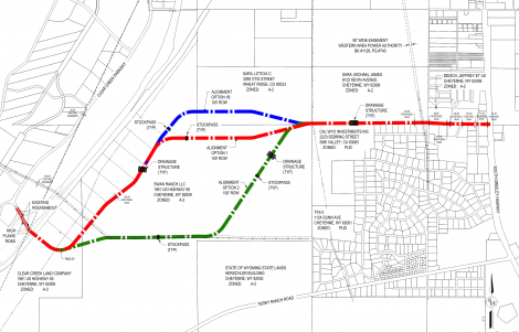 Annotated site map with red, blue, and green route lines across a development plan.