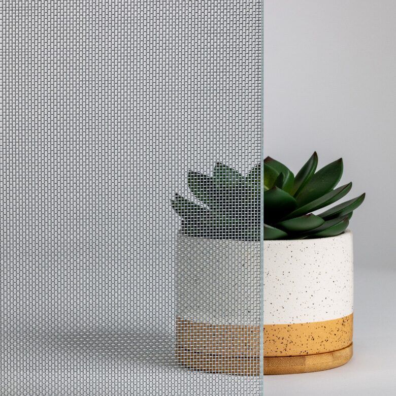 Textured glass panel with a mesh pattern, next to a potted succulent plant.