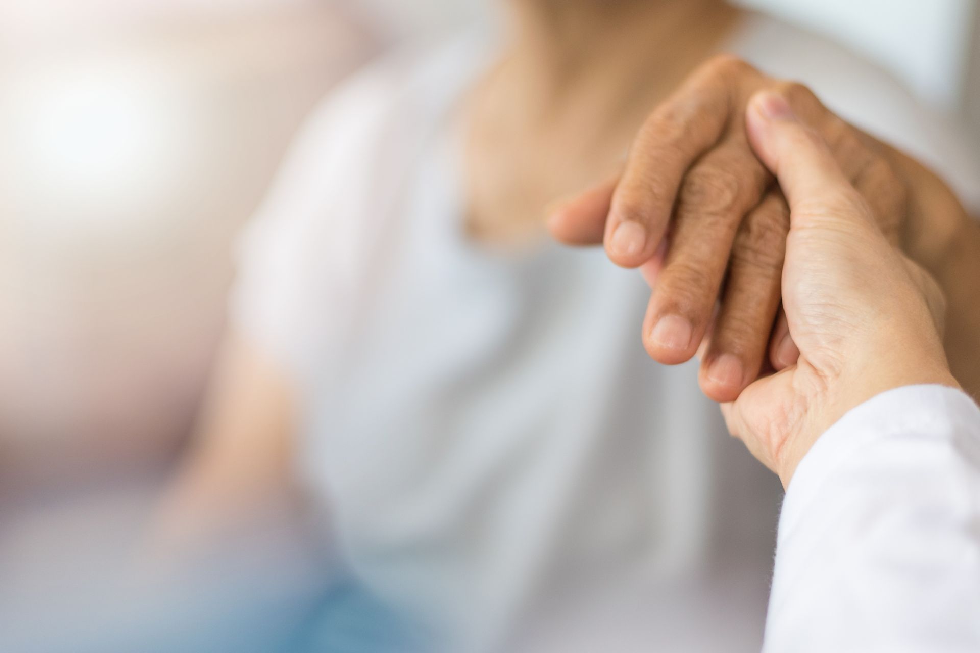 A close up of a person holding another person 's hand.